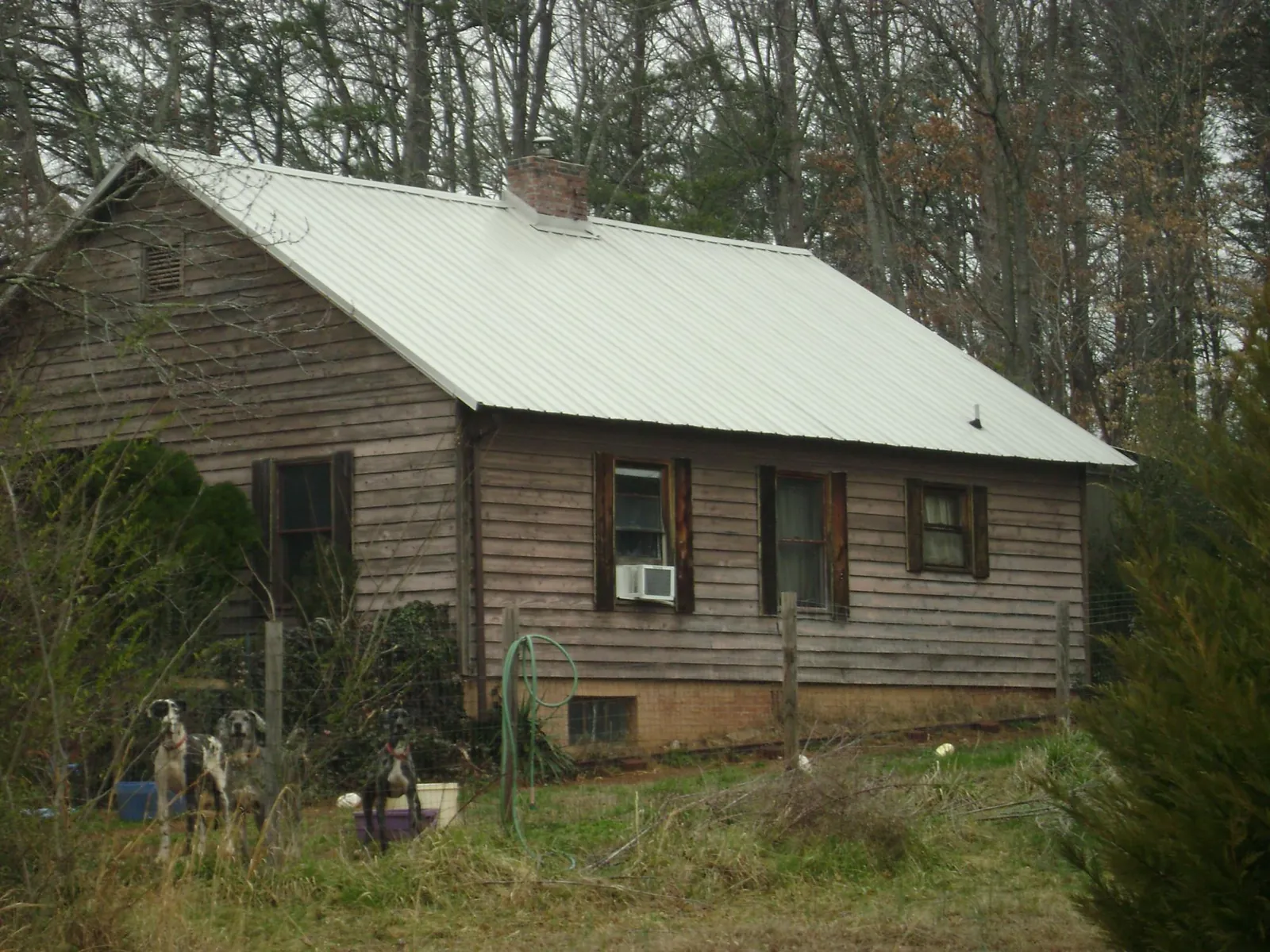 White metal roof on an old wood sided farmhouse, from a Metal Roof Installation job in Wallowa